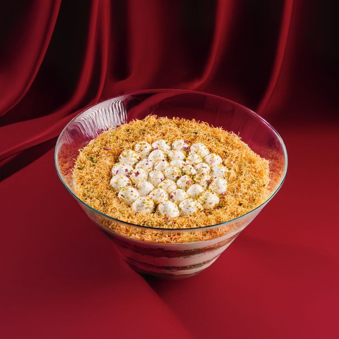 Chantilly Pistachio Kunafa Trifle dessert in a clear glass bowl with creamy layers and crispy topping